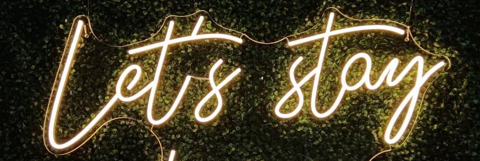 Let's Stay Home LED Neon Sign of Green Foliage wall at home